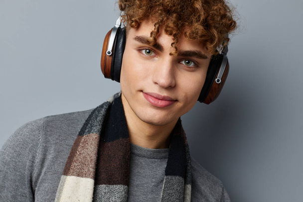 handsome guy plaid scarf wireless headphones technology isolated background - Zdjęcie, obraz