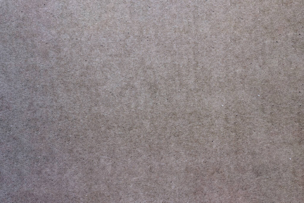 Shabby cardboard sheet. Paper texture with small spots and scratches. - Photo, Image