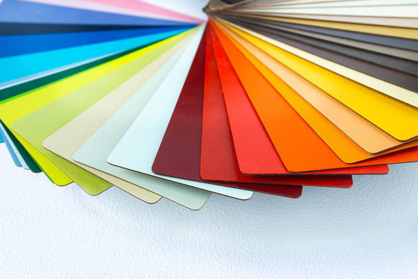 Color guide displaying a range of hues for use in interior design and decoration. Colorful color guide with palette of paint samples on white background with copy space. Catalog for tinting - Foto, imagen