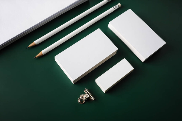 Branding stationery mockup on green background. White objects for placing your design. - Photo, Image
