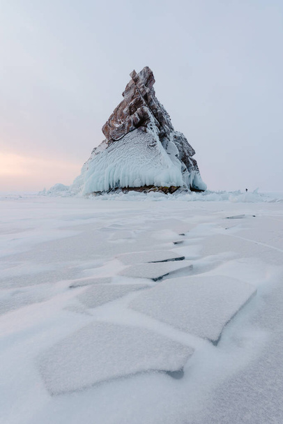 Lonely rock - an island on Lake Baikal under a layer of ice and snow - Fotó, kép