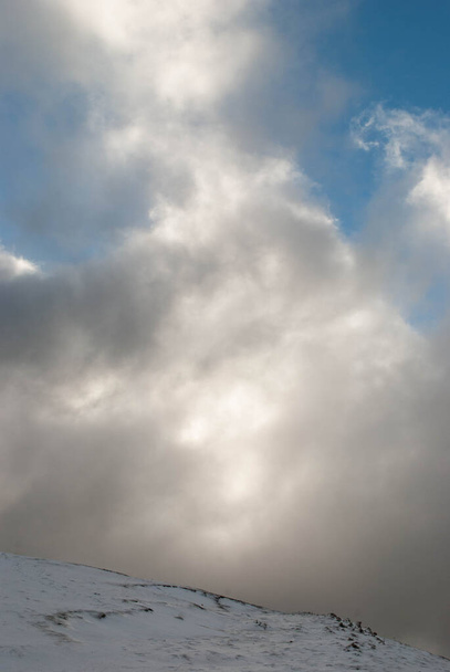 Vuoristoinen maisema lumi ja suuret valkoiset pilvet ilmoittavat myrsky ja kovat tuulet - Valokuva, kuva