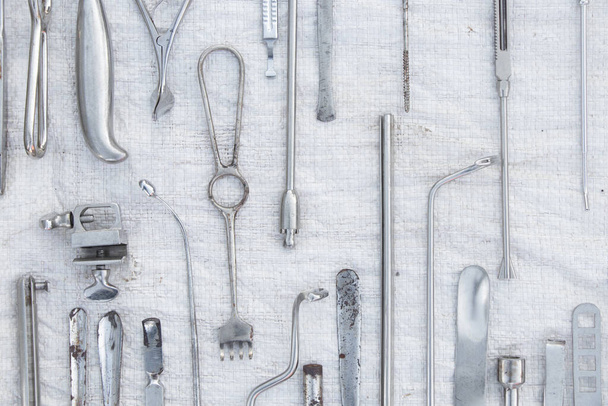 set of old medical instruments clamps ,scalpels and scissors on a white background ,medical practice - Foto, Imagen