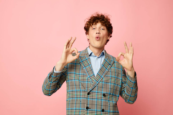 Young curly-haired man gesturing with his hands emotions checkered jacket Lifestyle unaltered - Fotó, kép
