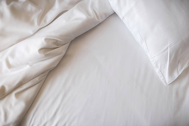 White bedding sheets and pillow in bedroom. Morning lifestyle concept. - Fotografie, Obrázek