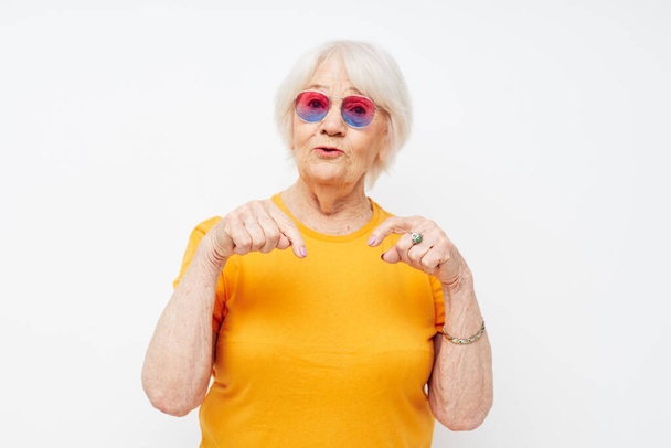 Photo of retired old lady happy lifestyle in yellow t-shirts close-up emotions - 写真・画像