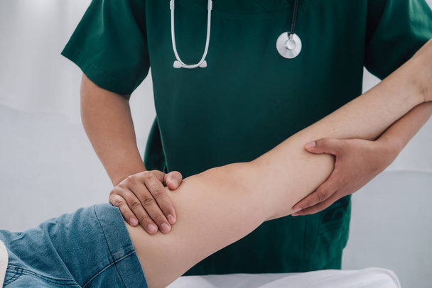 Treating thigh pain due to sitting for long periods of time Concept of physical rehabilitation. Consultation therapist with the treatment of treating injured thigh pain in modern clinics. - Fotó, kép