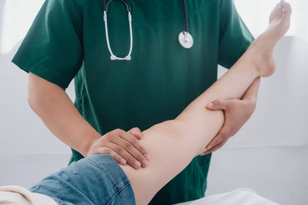 Treating thigh pain due to sitting for long periods of time Concept of physical rehabilitation. Consultation therapist with the treatment of treating injured thigh pain in modern clinics. - Valokuva, kuva