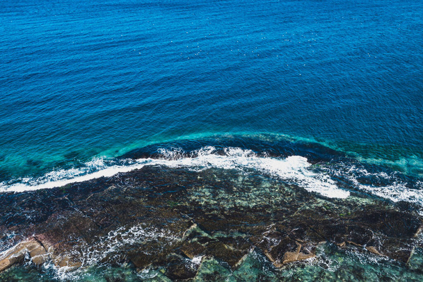 Aerial top view of sea waves hitting rocks. Amazing rock cliff seascape in the coastline. Sea of Japan - Foto, immagini