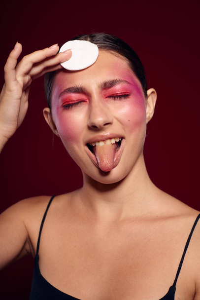Portrait of beautiful young woman pink face makeup posing attractive look skin care cropped view unaltered - 写真・画像