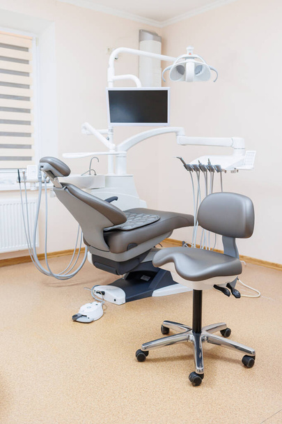 Modern stylish bright dental office with a new chair for receiving patients. selective focus - Foto, afbeelding