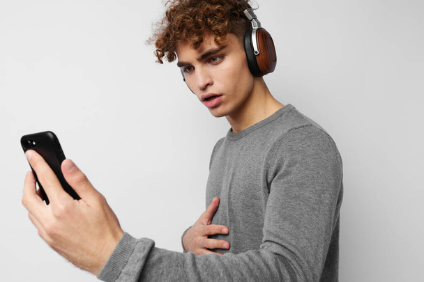handsome guy headphone music technology with phone isolated background - Foto, Imagem