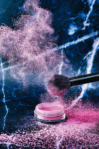 Make up cosmetic brushes with an explosion of powder blush on a beautiful background. Skin care or fashion concept - Photo, Image