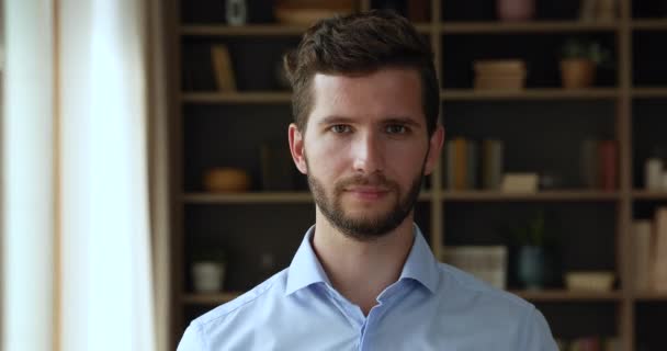 Headshot portrait millennial guy employee businessman smiling at home office - Video