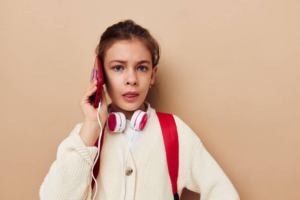girl with backpack in headphones with phone technology - Φωτογραφία, εικόνα