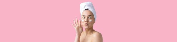 Beauty portrait of woman in white towel on head applies cream to the face. Skincare cleansing eco organic cosmetic spa relax concept. - Photo, Image