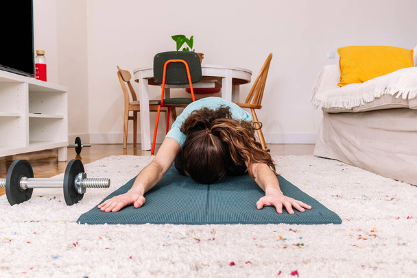 Woman stretching on mat at home. Fitness concept. - Fotografie, Obrázek