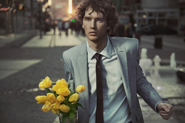 Attractive guy with bunch of tulips - Fotoğraf, Görsel