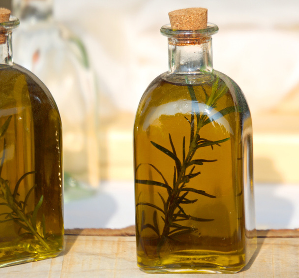Bottles of olive oil flavoured with wild Rosemary - 写真・画像