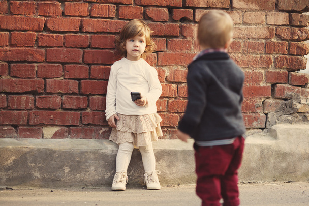 little boy and girl playing with phone - Φωτογραφία, εικόνα