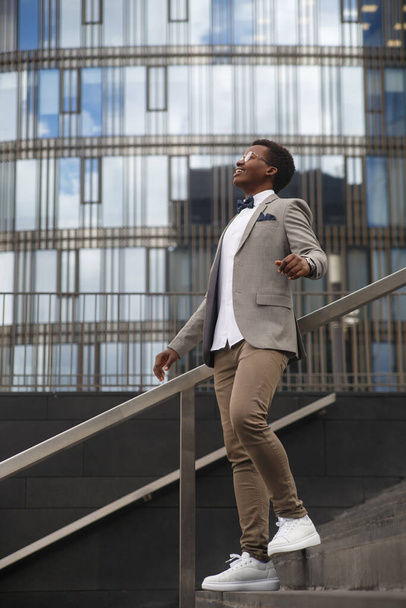 Cute black male businessman on the background of an office building. - Fotoğraf, Görsel