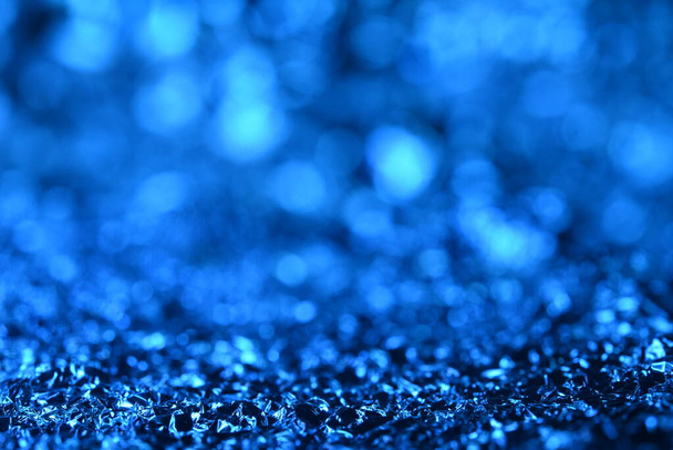 Blue glitter lights texture. Abstract christmas background. - Foto, afbeelding
