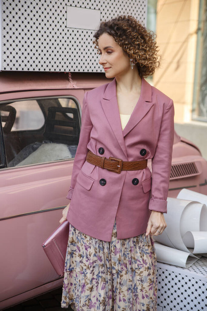 Portrait of pretty stylish woman in lilac in the city. - 写真・画像
