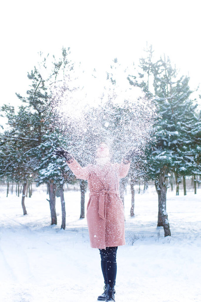 Young cute girl with durk hair has fun in snowy weather in winter in the park. Life style  - Foto, Imagen