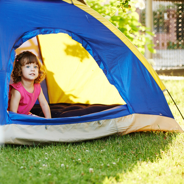little beautiful girl sitting in tent - Фото, изображение