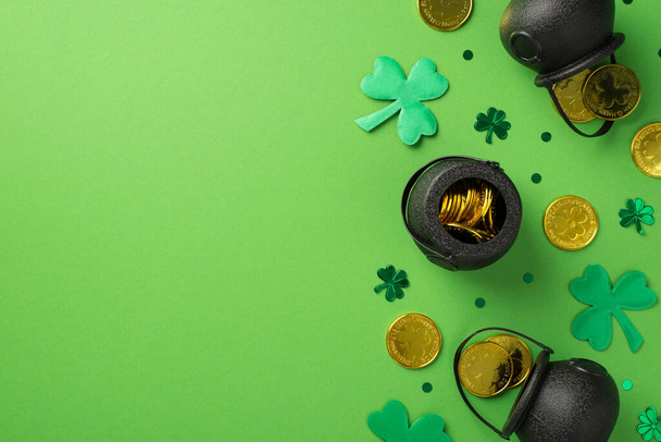 Top view photo of st patrick's day decorations pots with gold coins green shamrocks and clover shaped confetti on isolated pastel green background with copyspace - Photo, Image