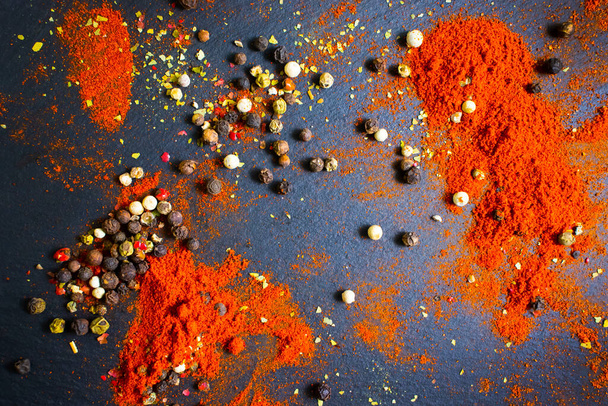 spices turmeric, pepper in on a dark background - Fotoğraf, Görsel