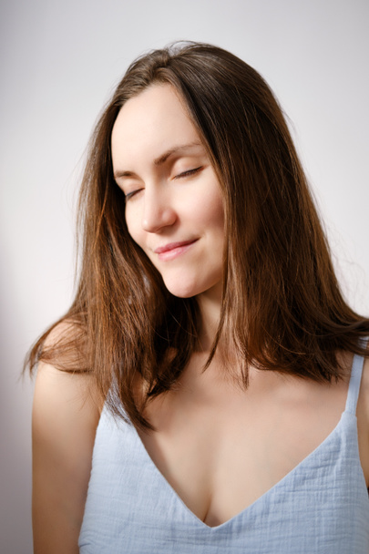 authentic portrait of caucasian brunette woman with closed eyes without makeup in blue T-shirt, mature woman, vertical, natural beauty - Φωτογραφία, εικόνα