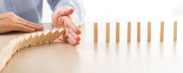 Plan and strategy in business, Risk To Make Business Growth Concept With Wooden Blocks, hand of man has piling up and stacking a wooden block - Foto, Imagen