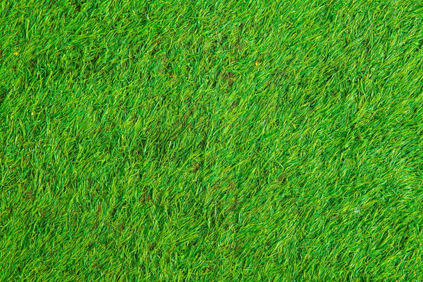 Nieuwe groene kunstgras vloeren textuur en achtergrond naadloos - Foto, afbeelding