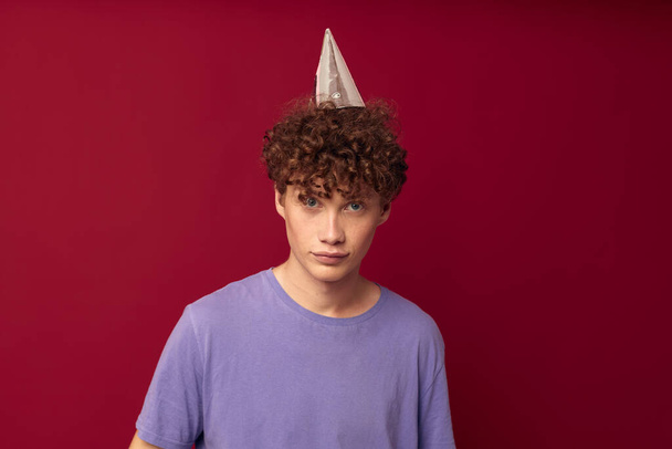teenager in purple t-shirts posing emotions isolated background unaltered with a cap on his head - Foto, Bild