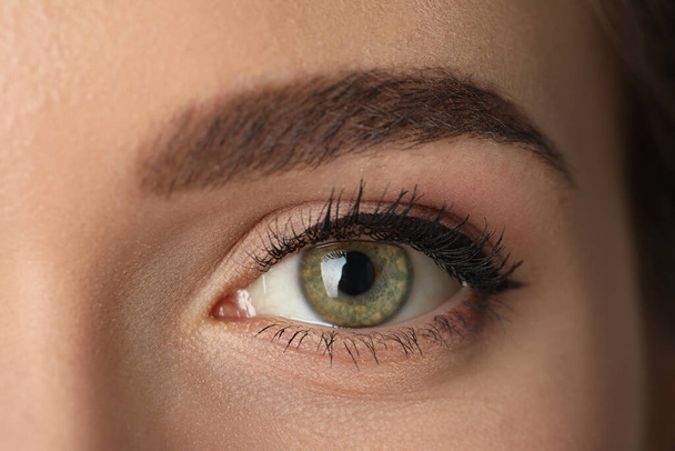 Beautiful woman with perfect eyebrow, closeup. Permanent makeup - Фото, изображение