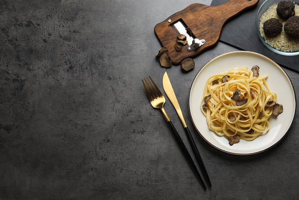 Tasty fettuccine with truffle served on grey table, flat lay. Space for text - Fotografie, Obrázek