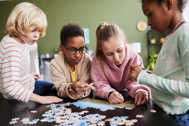 Group of Kids Playing with Jigsaw Puzzle - Photo, Image
