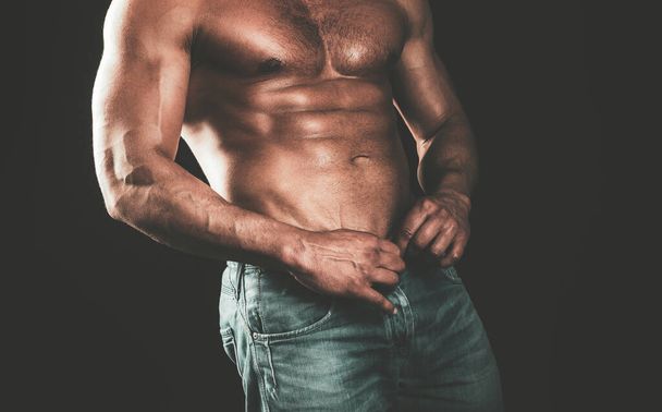 Beautiful muscular male model with nice abs in jeans. Athletic man with ab, abs or six pack. Chest muscles. Male torso. - Foto, imagen