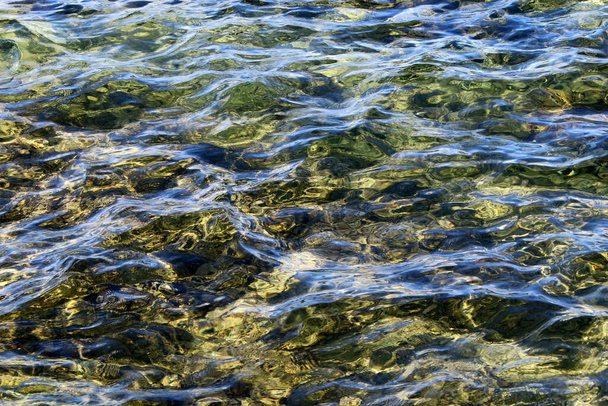 The color of salty sea water in shallow waters in the Mediterranean Sea. Abstract background and texture of sea water.  - Photo, Image