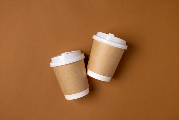 Coffee craft paper cups with place for logo on brown background, natural color, for menu and restaurants  - Фото, зображення