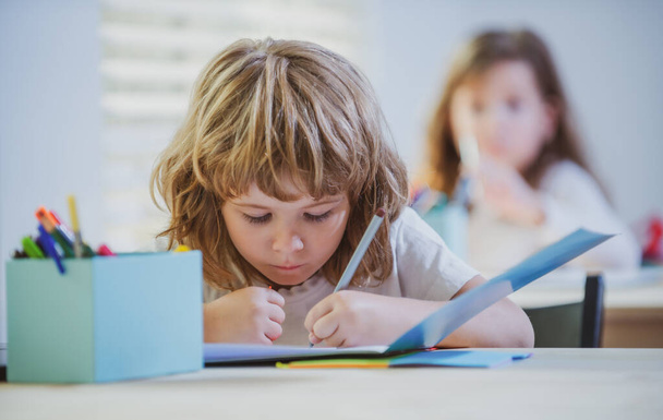 Kid studying at school. Schoolchild doing homework at classroom. Education for kids. - Valokuva, kuva