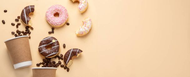 Donuts with coffee on yellow background. Bakery, baking concept. Flat lay, top view, copy space, panorama - Zdjęcie, obraz