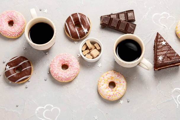 fresh donut with coffee on grey background, top view - Zdjęcie, obraz