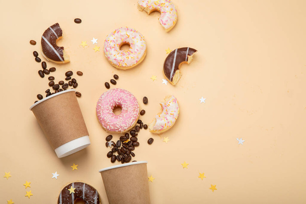 Donuts with coffee on yellow background. Bakery, baking concept. Flat lay, top view, copy space - Photo, image