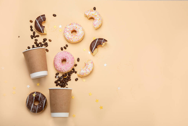 Donuts with coffee on yellow background. Bakery, baking concept. Flat lay, top view, copy space - Фото, зображення