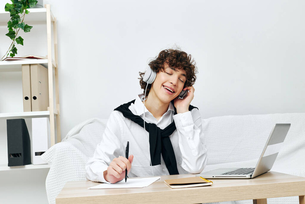 curly guy in headphones with a book at home Lifestyle technology - Fotoğraf, Görsel