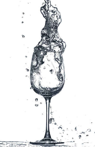 Glass of clean water with splash on white background - Photo, image