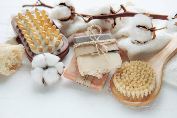 Concept of spa with natural organic handmade soap. Moisturizing skin care and aromatherapy. Gentle body treatment. Handmade soap. Atmosphere of harmony, relax. flowers, candle - Photo, Image