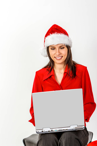Young woman in red clothes and hat working on a laptop. - Foto, Imagem